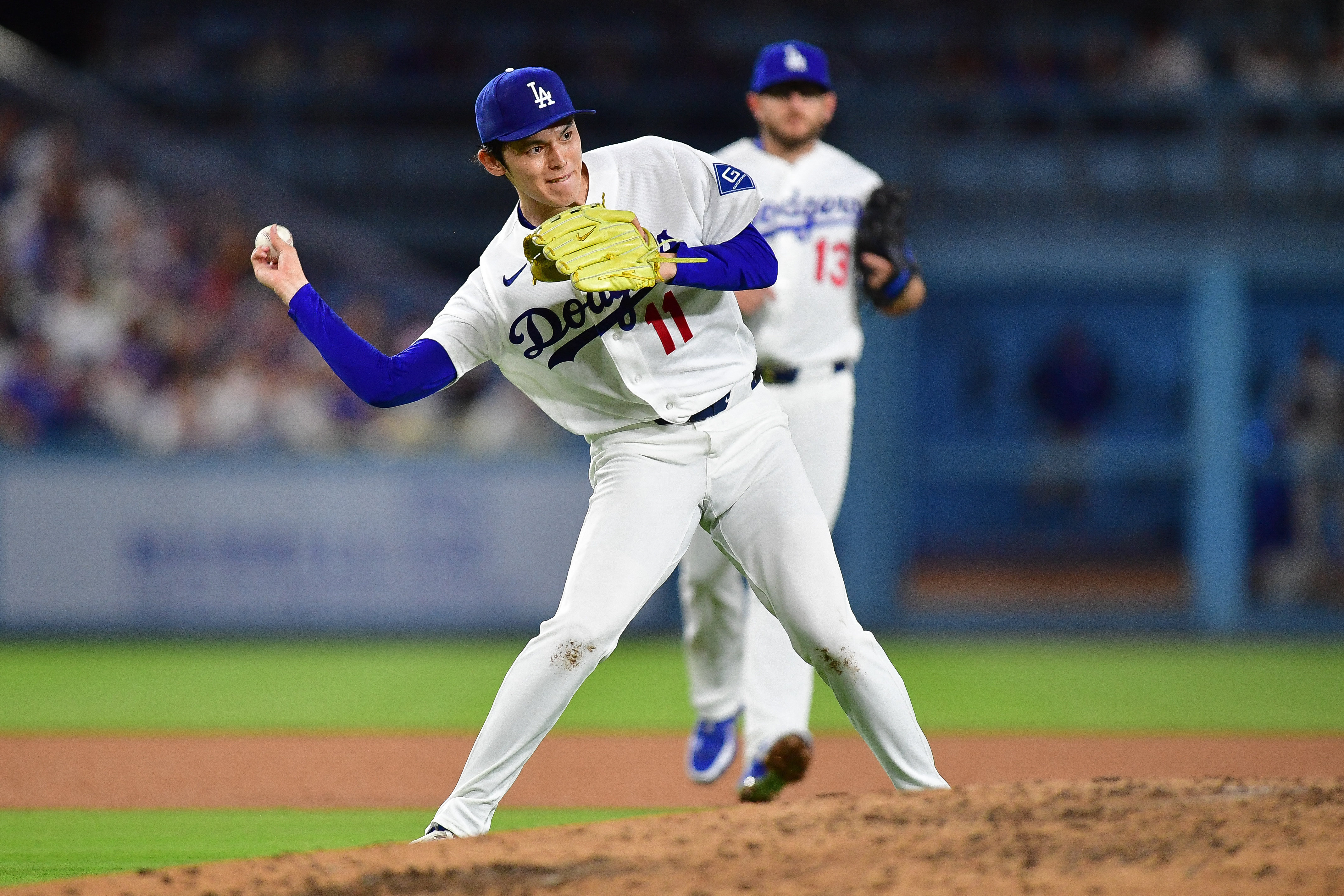 Los Angeles Dodgers pitcher Roki Sasaki throws to first as we make our best Dodgers vs. Yankees prediction.