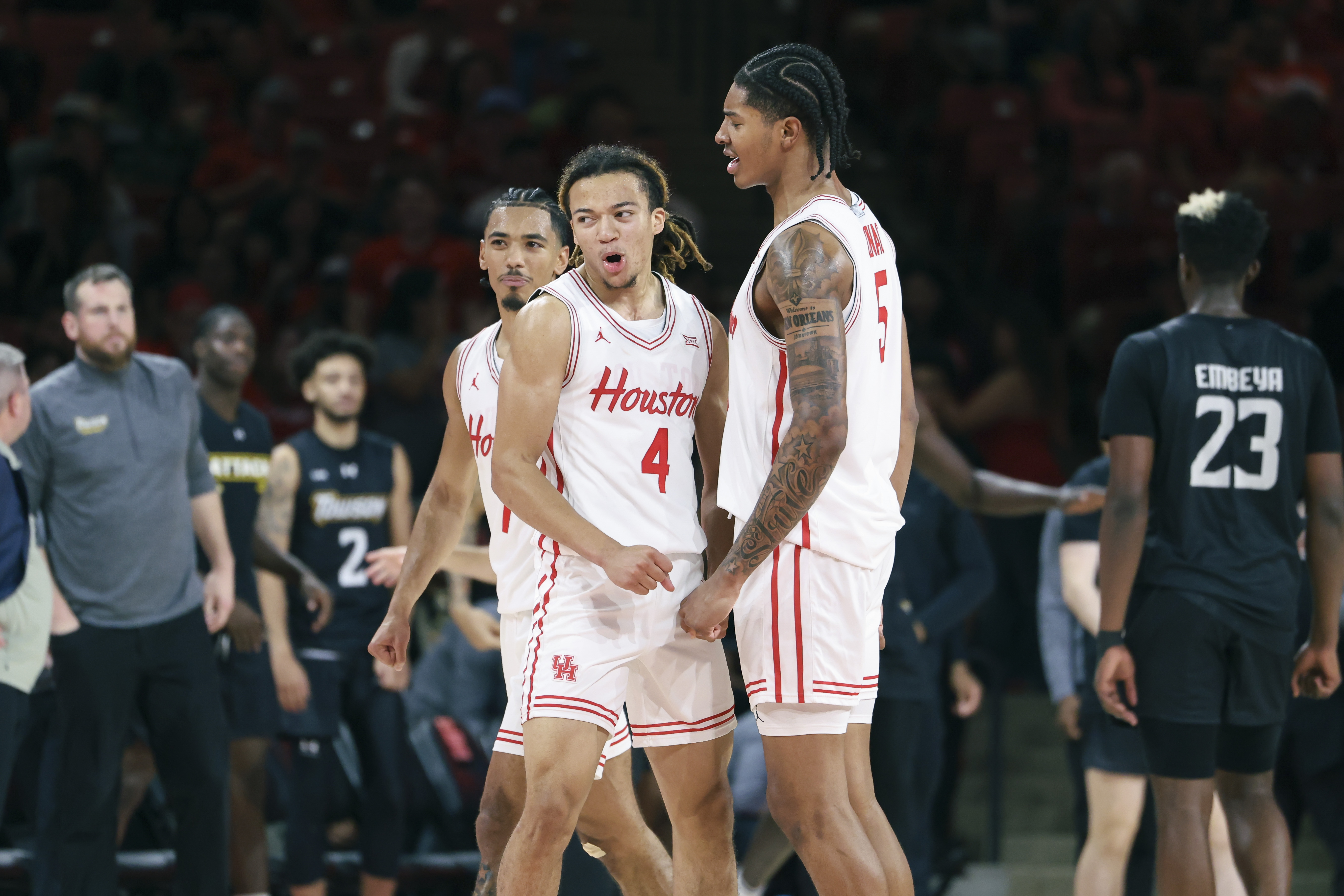 Houston Cougars guard Kingston Flemings (4) celebrates with teammates as we dive into our Rider vs. Houston prediction, betting odds, and expert picks.