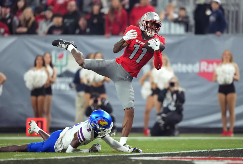 UNLV wide receiver Ricky White catches a touchdown pass against Kansas. We're backing UNLV to cover in our UNLV vs. Kansas prediction.