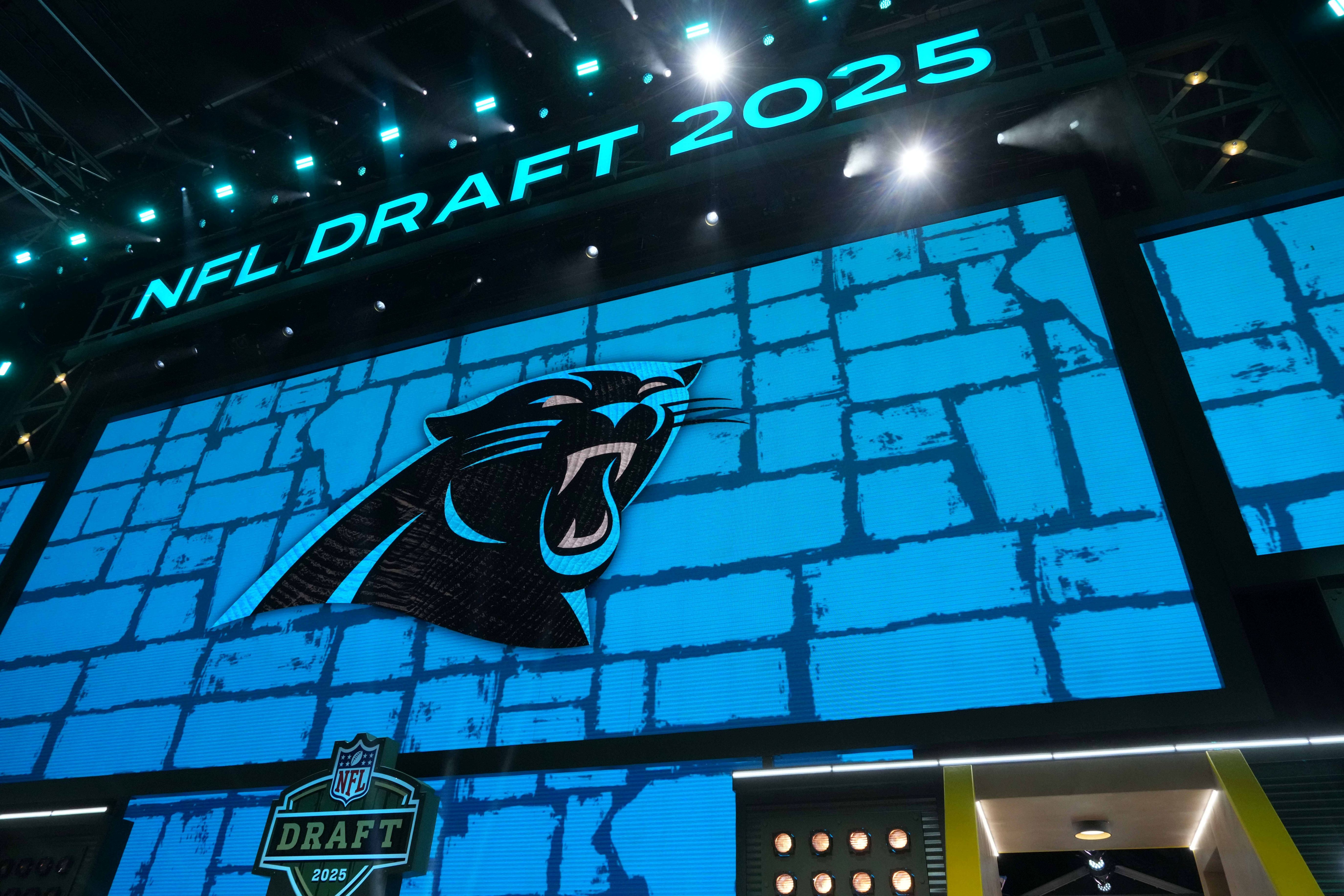 The Carolina Panthers logo is projected on the video board during the NFL Draft at Lambeau Field.