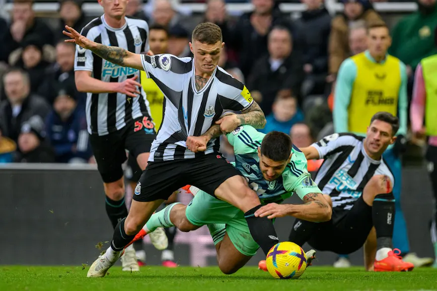Fulham's Aleksandar Mitrovic pulls down Newcastle's Kieran Trippier. 