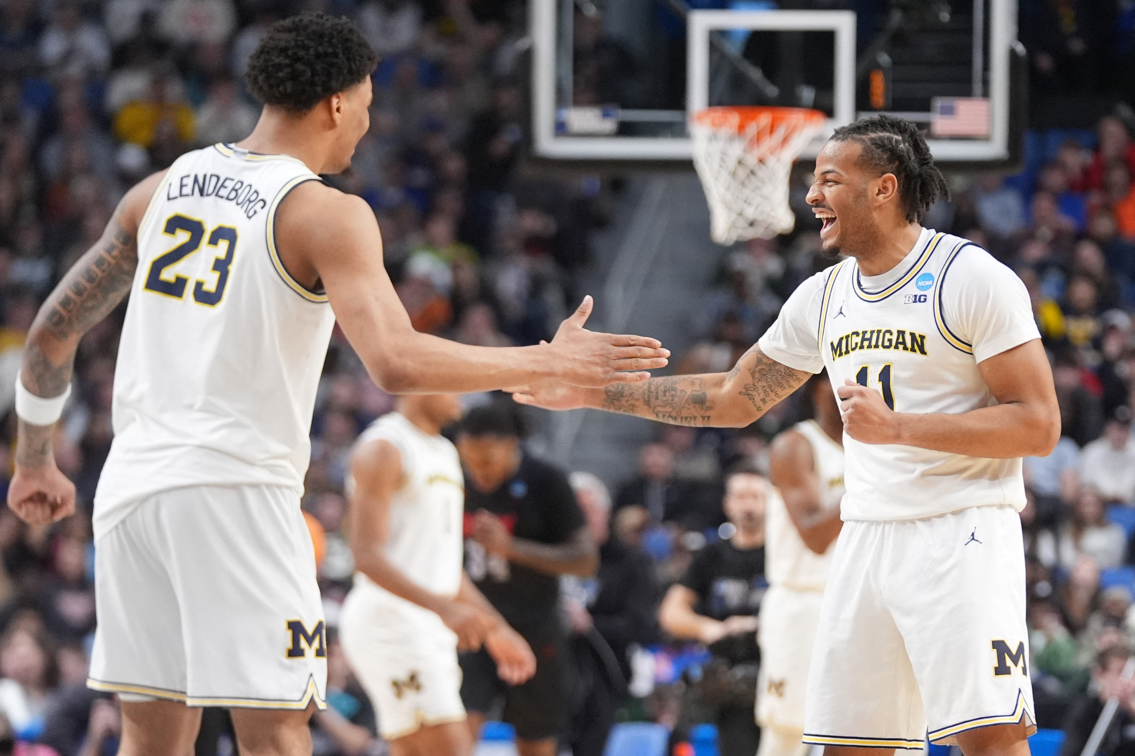 Michigan's Yaxel Lendeborg and Roddy Gayle Jr. celebrate the Wolverines Round 1 win over Howard, as we break down the March Madness odds. 