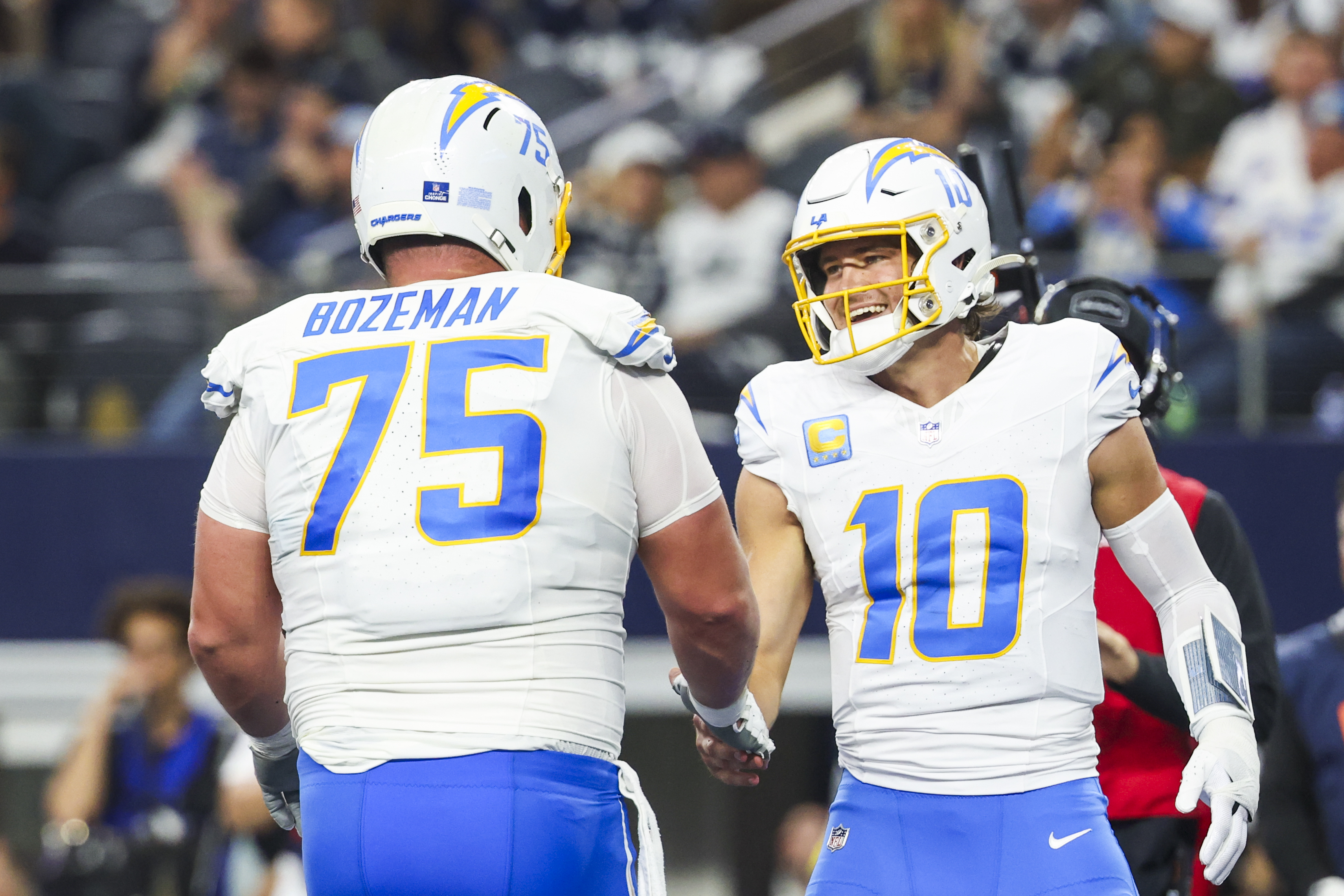 Los Angeles Chargers quarterback Justin Herbert (10) celebrates with center Bradley Bozeman (75) as we break down our Chargers vs. Patriots AI picks for NFL Wild Card Weekend.