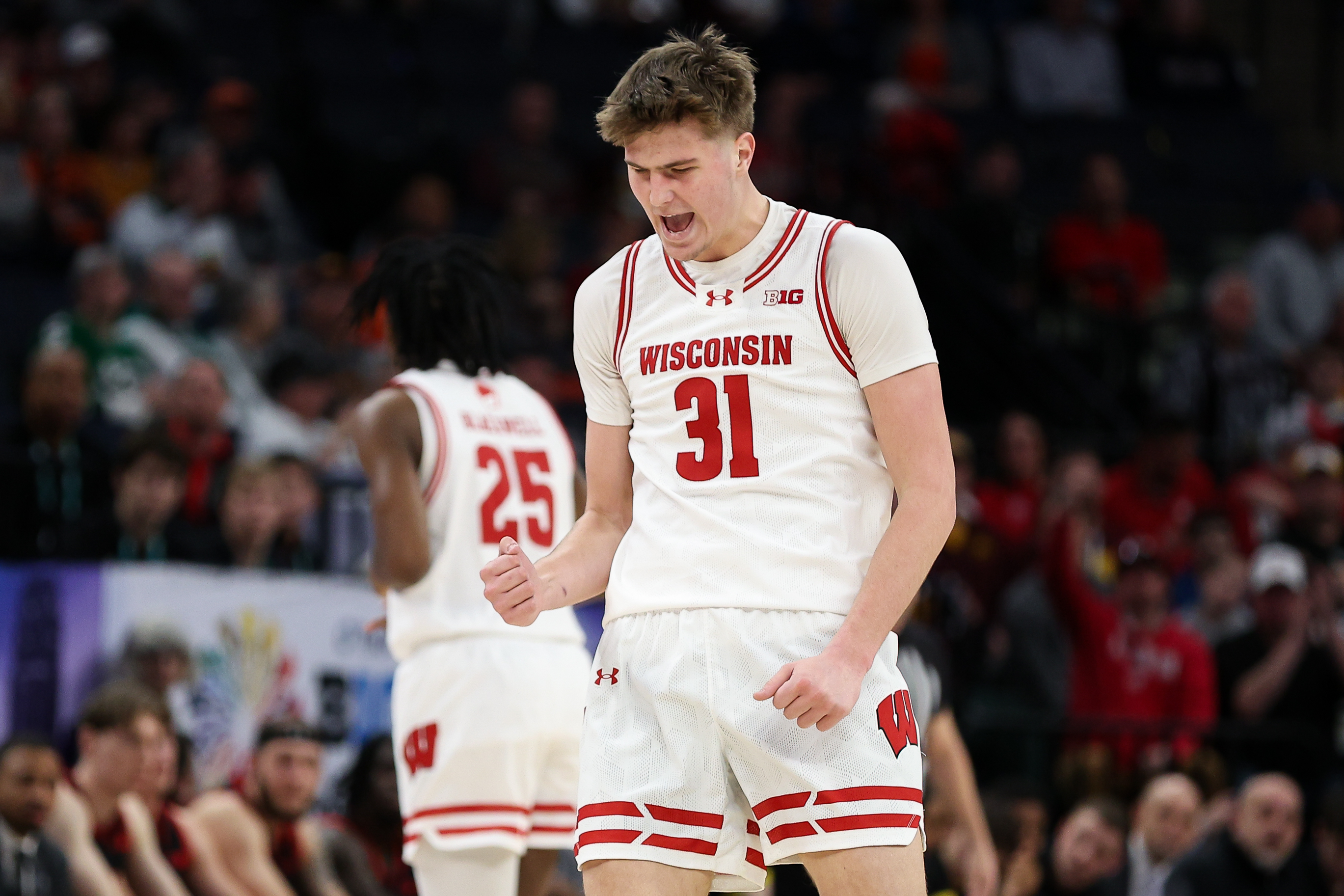 Wisconsin Badgers forward Nolan Winter (31) celebrates a basket as we break down our college basketball predictions today.