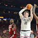 Donovan Clingan #32 of the Connecticut Huskies attempts a shot as we offer our best Purdue vs. UConn player props and predictions for the men's national championship game on Monday at State Farm Stadium in Glendale, Ariz.