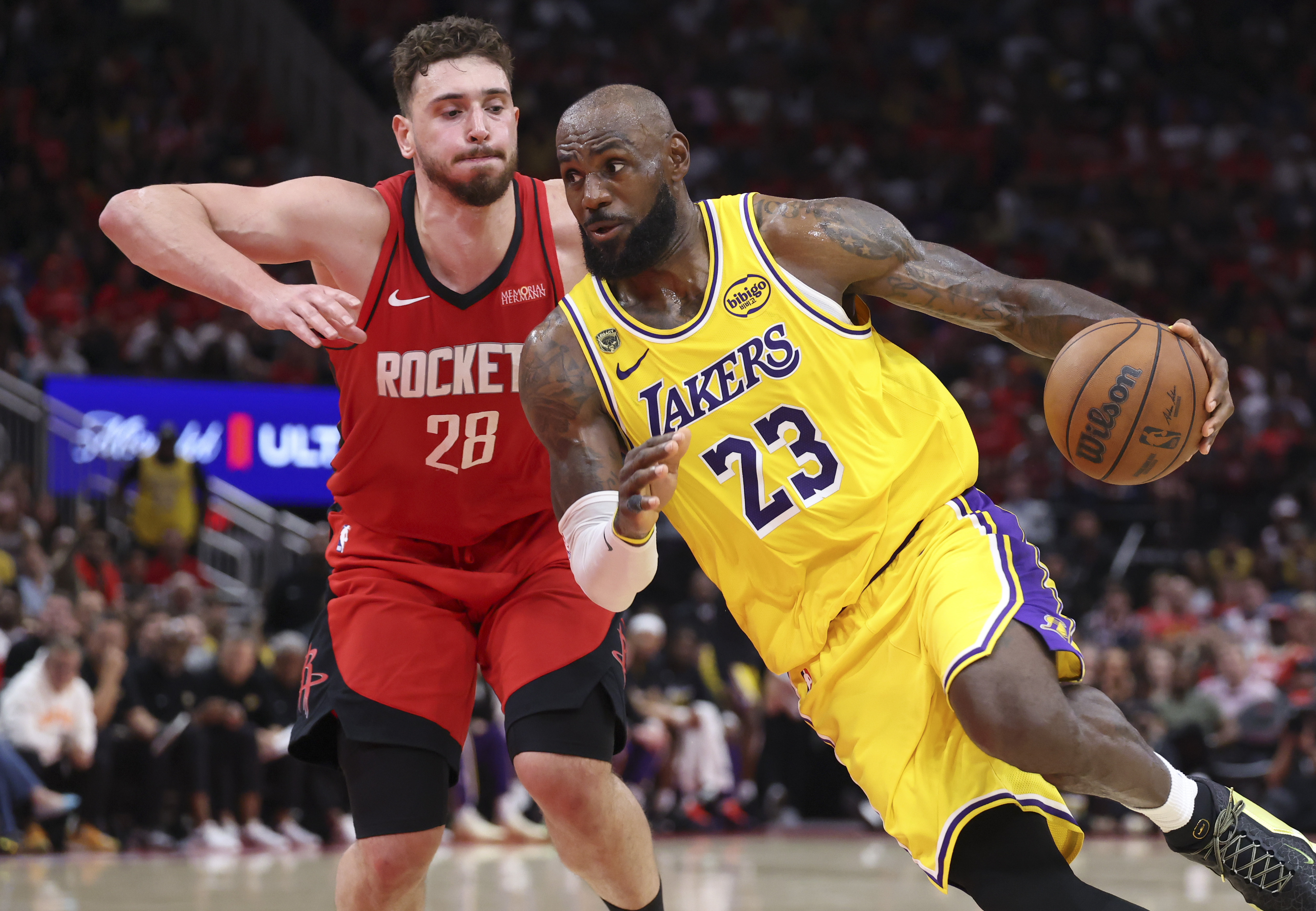 Los Angeles Lakers forward LeBron James (23) drives with the ball against Houston Rockets center Alperen Sengun (28) as we provide our Lakers vs. Rockets Game 4 player props.