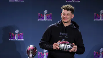Quarterback Patrick Mahomes #15 of the Kansas City Chiefs poses with the MVP award as we look at the American Gaming Association's February report