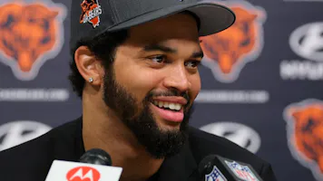 Chicago Bears QB Caleb Williams (18) answers a question during his introductory press conference, as we examine the 2024 NFL rookie passing leader odds with Williams as the betting favorite.
