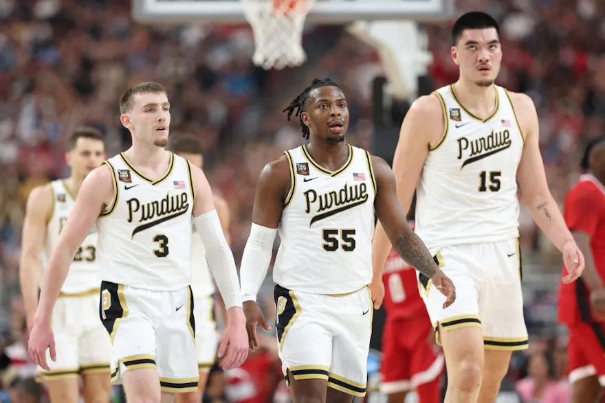 Braden Smith, Lance Jones, and Zach Edey of the Purdue Boilermakers walk across the court against the NC State Wolfpack in the NCAA Men's Basketball Tournament Final Four. We're breaking down Purdue in our 2024 National Championship Game Odds.