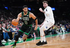 Boston Celtics forward Jayson Tatum (0) drives the ball against Dallas Mavericks guard Luka Doncic (77), as we offer our best NBA Finals Game 1 player props and expert predictions.
