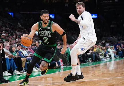 Boston Celtics forward Jayson Tatum (0) drives the ball against Dallas Mavericks guard Luka Doncic (77), as we offer our best NBA Finals Game 1 player props and expert predictions.