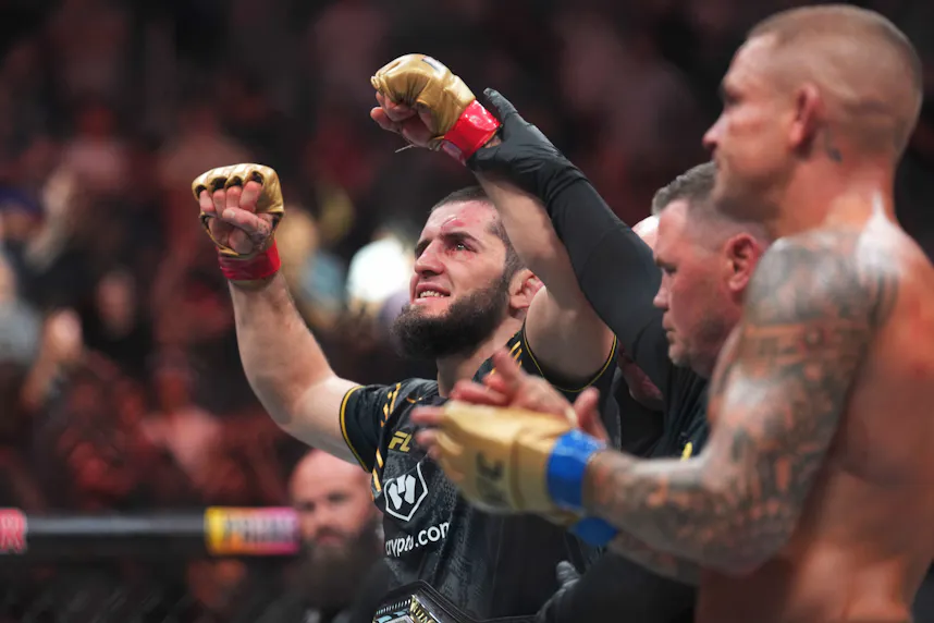 Islam Makhachev (red gloves) celebrates a win in the Octagon as we look at our Islam Makhachev vs. Renato Moicano prediciton.