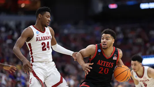 Matt Bradley of the San Diego State Aztecs drives against Brandon Miller of the Alabama Crimson Tide during the Sweet 16 round of the NCAA Men's Basketball Tournament at KFC YUM! Center on Mar. 24, 2023 in Louisville, Kentucky.
