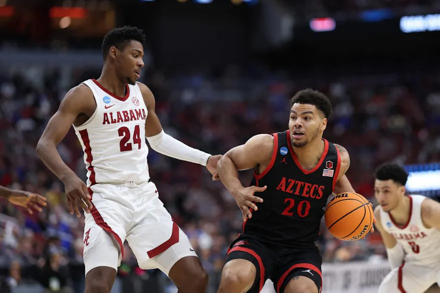 Matt Bradley of the San Diego State Aztecs drives against Brandon Miller of the Alabama Crimson Tide during the Sweet 16 round of the NCAA Men's Basketball Tournament at KFC YUM! Center on Mar. 24, 2023 in Louisville, Kentucky.