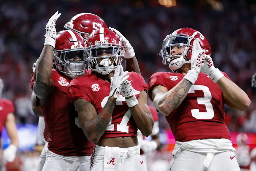 Isaiah Bond, Jermaine Burton, and Roydell Williams of the Alabama Crimson Tide react after a catch against the Georgia Bulldogs.