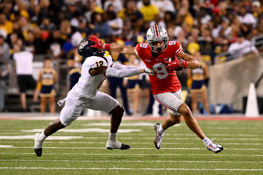 Jayden Ballard of the Ohio State Buckeyes stiff-arms Avery Smith of the Toledo Rockets as he runs with the ball during the third quarter.