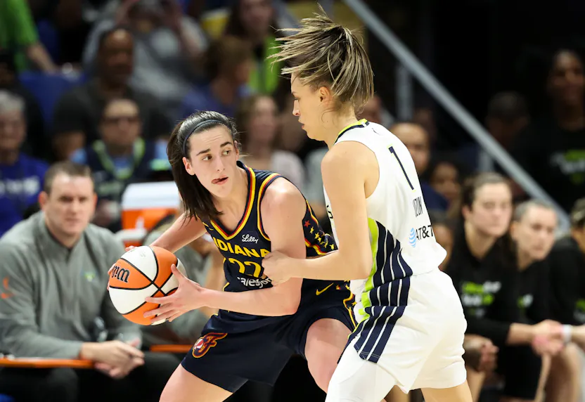 Indiana Fever guard Caitlin Clark (22) controls the ball as we offer our best Fever vs. Wings prediction and expert picks for Wednesday's WNBA matchup at College Park Center in Arlington, Texas.