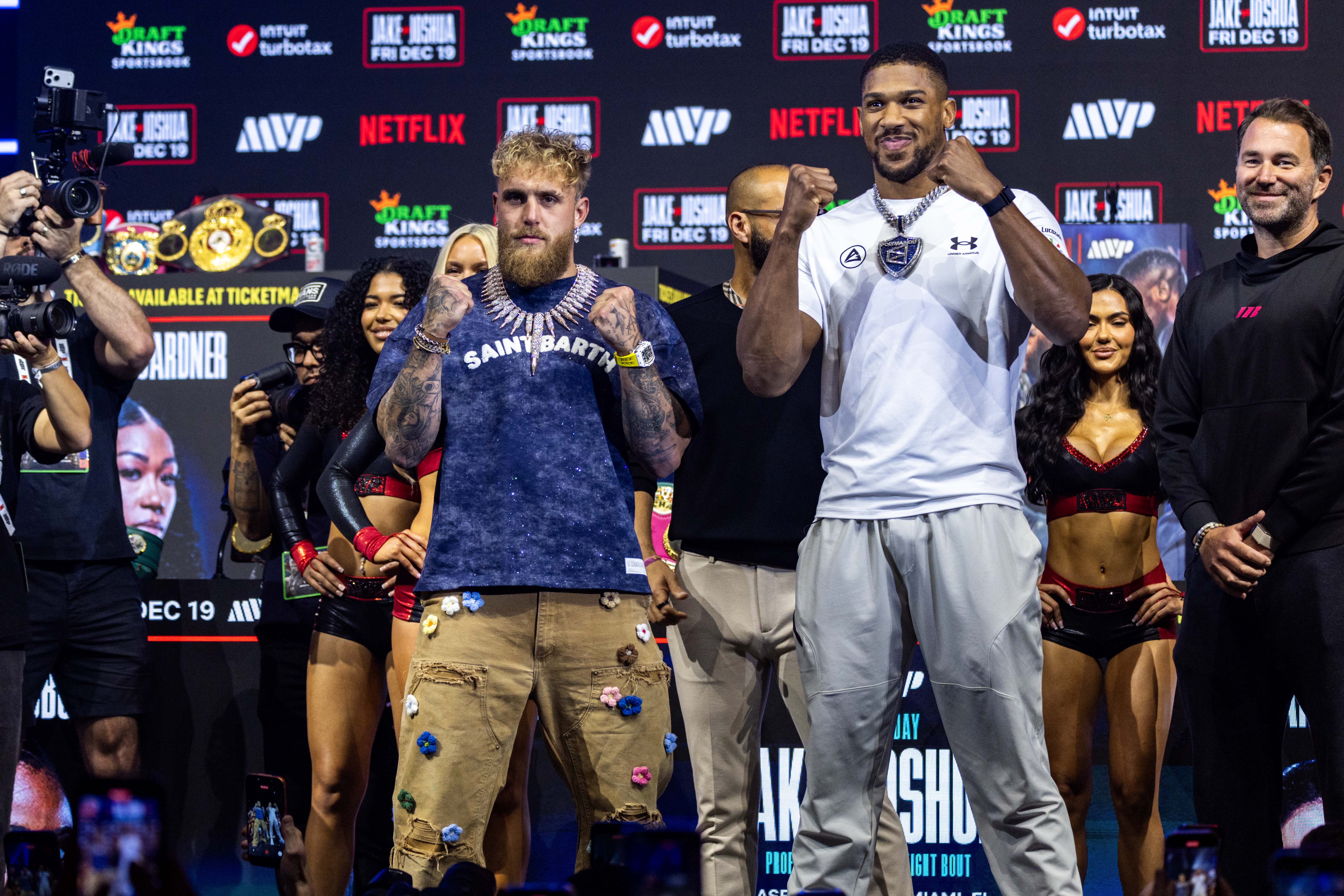 Jake Paul and Anthony Joshua face the media during the press conference.