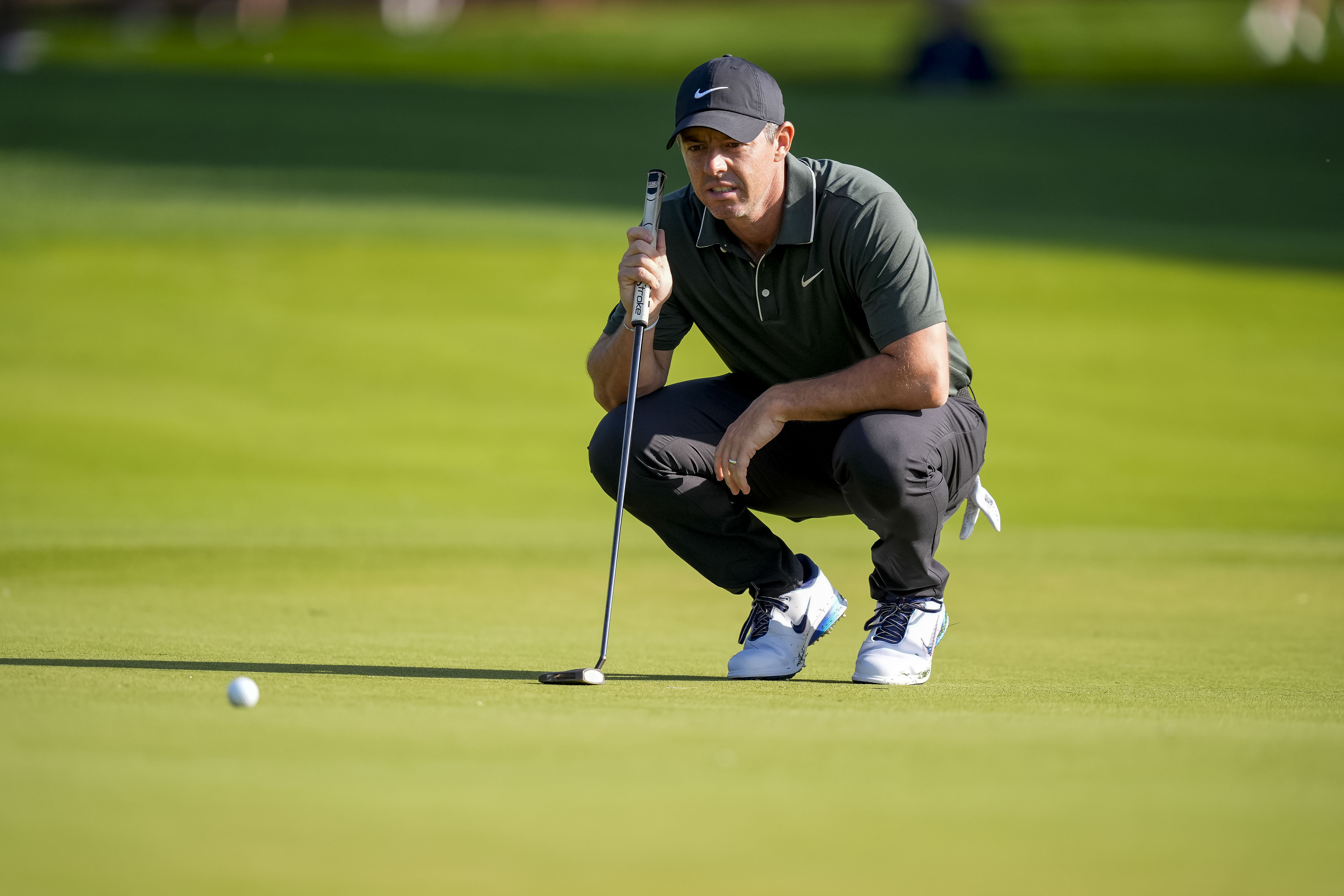 Rory McIllroy lines up his ball on green at the 10th hole. 
