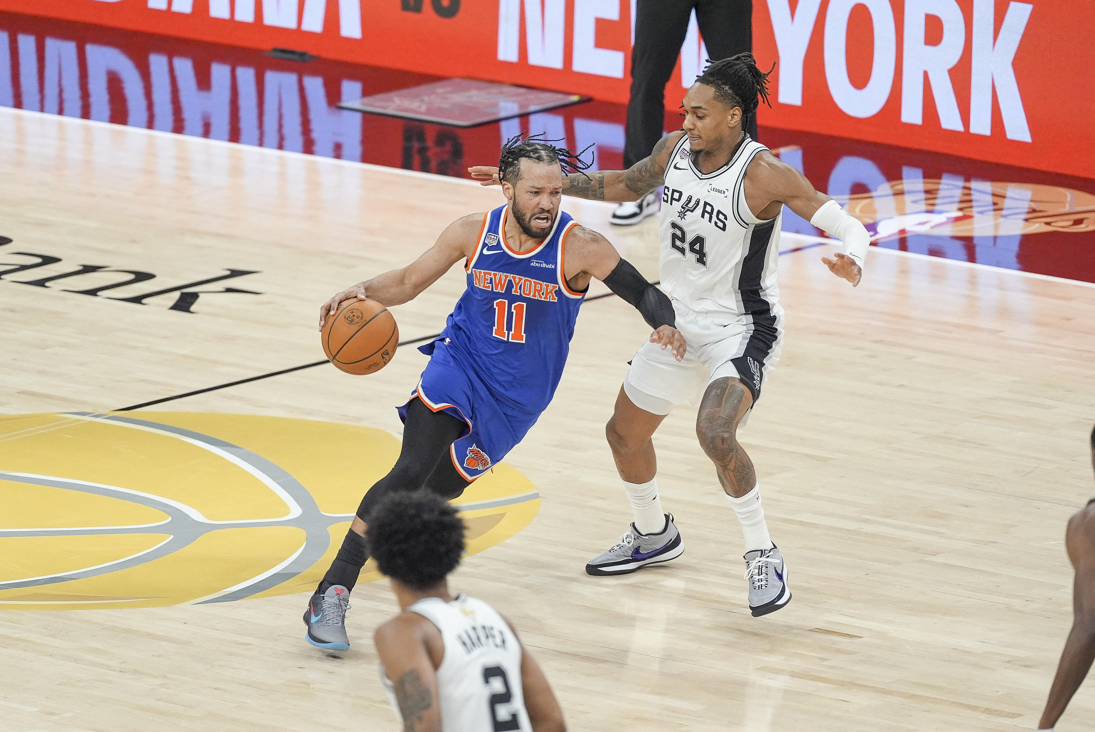 New York Knicks guard Jalen Brunson (11) moves the ball past San Antonio Spurs guard Devin Vassell (24), and both are featured in our Knicks vs. Spurs player props today.