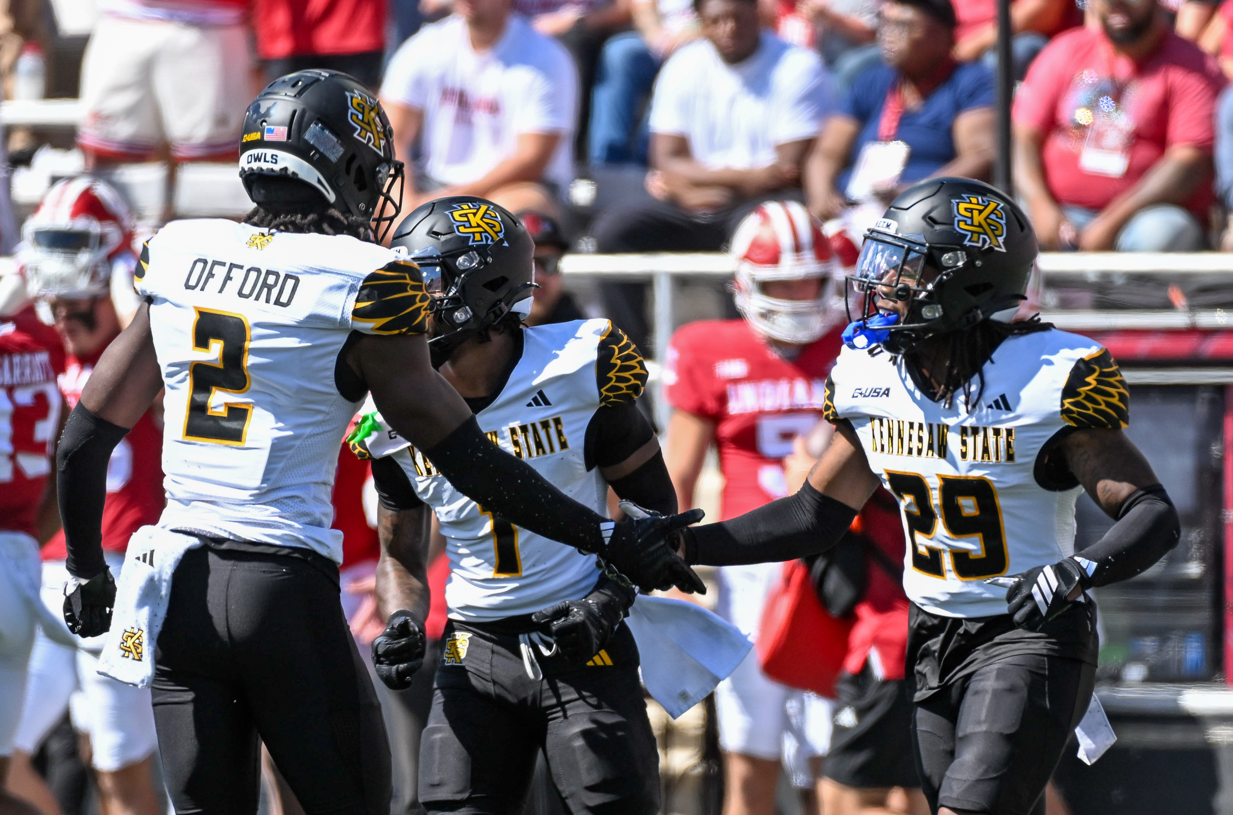 Kennesaw State Owls defensive backs Caleb Offord and Milon Jones celebrate as we offer our best Kennesaw State vs. Western Michigan predictions.