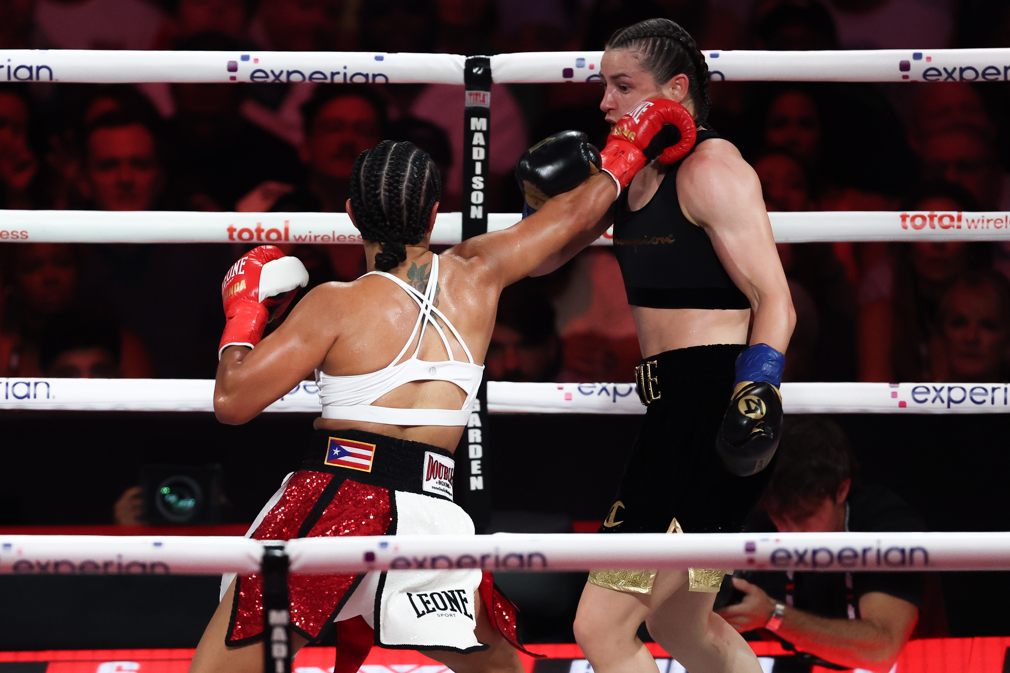 Amanda Serrano (red gloves) throws a punch as we break down our Amanda Serrano vs. Reina Tellez odds, fight lines & prediction.