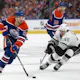 Connor McDavid skates the puck past Blake Lizotte as we provide our best prop picks and predictions for Game 1 of the second-round series between the Edmonton Oilers and Vancouver Canucks. 