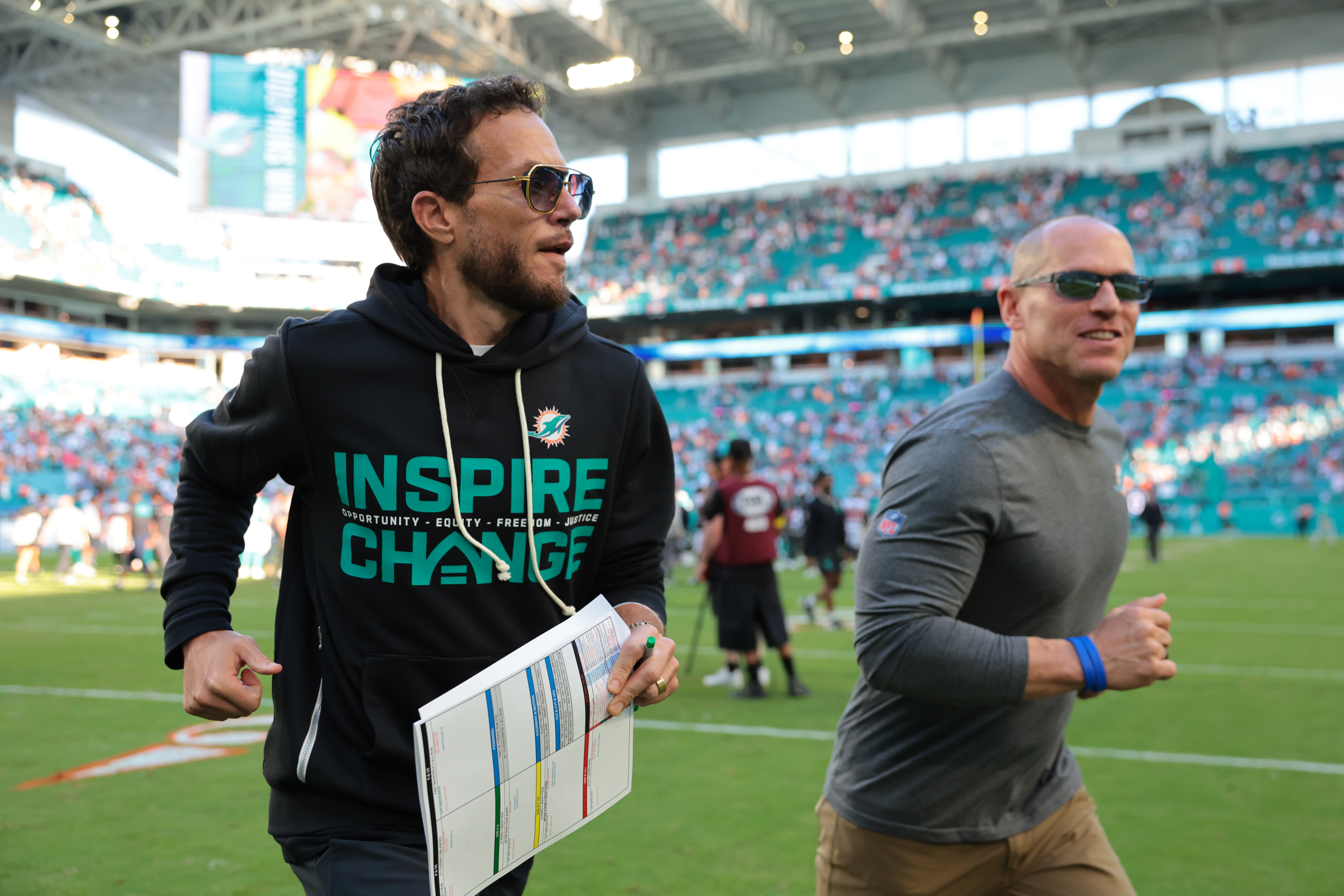 Miami Dolphins head coach Mike McDaniel, who is featured in our NFL head coach tracker, runs off the field.