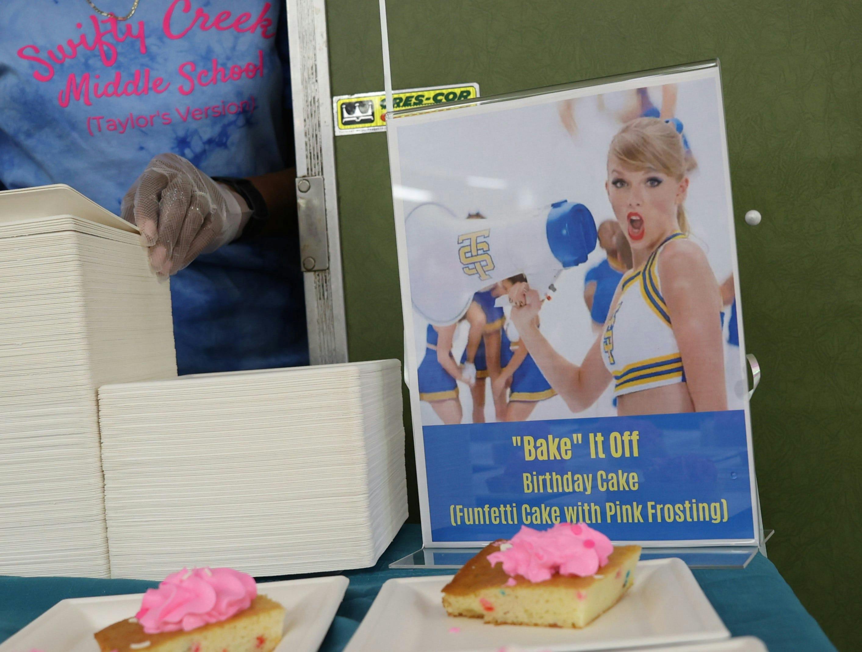 Erlene Preston sets up plates of "Bake It Off" birthday cake at a celebration for Taylor Swift