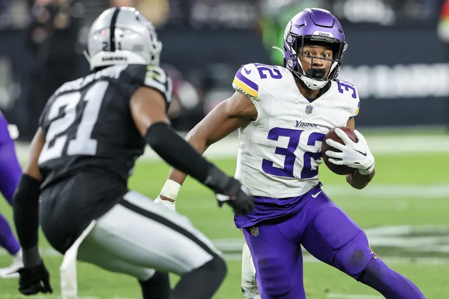 Ty Chandler of the Minnesota Vikings runs the ball against Amik Robertson of the Las Vegas Raiders, and we offer our top Packers vs. Vikings prediction based on the best NFL odds.