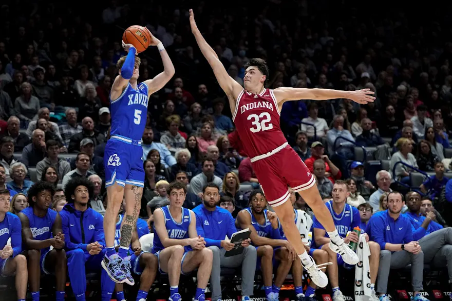 Adam Kunkel of the Xavier Musketeers attempts a shot while being guarded by Trey Galloway of the Indiana Hoosiers in the second half at the Cintas Center on November 18, 2022 in Cincinnati, Ohio.