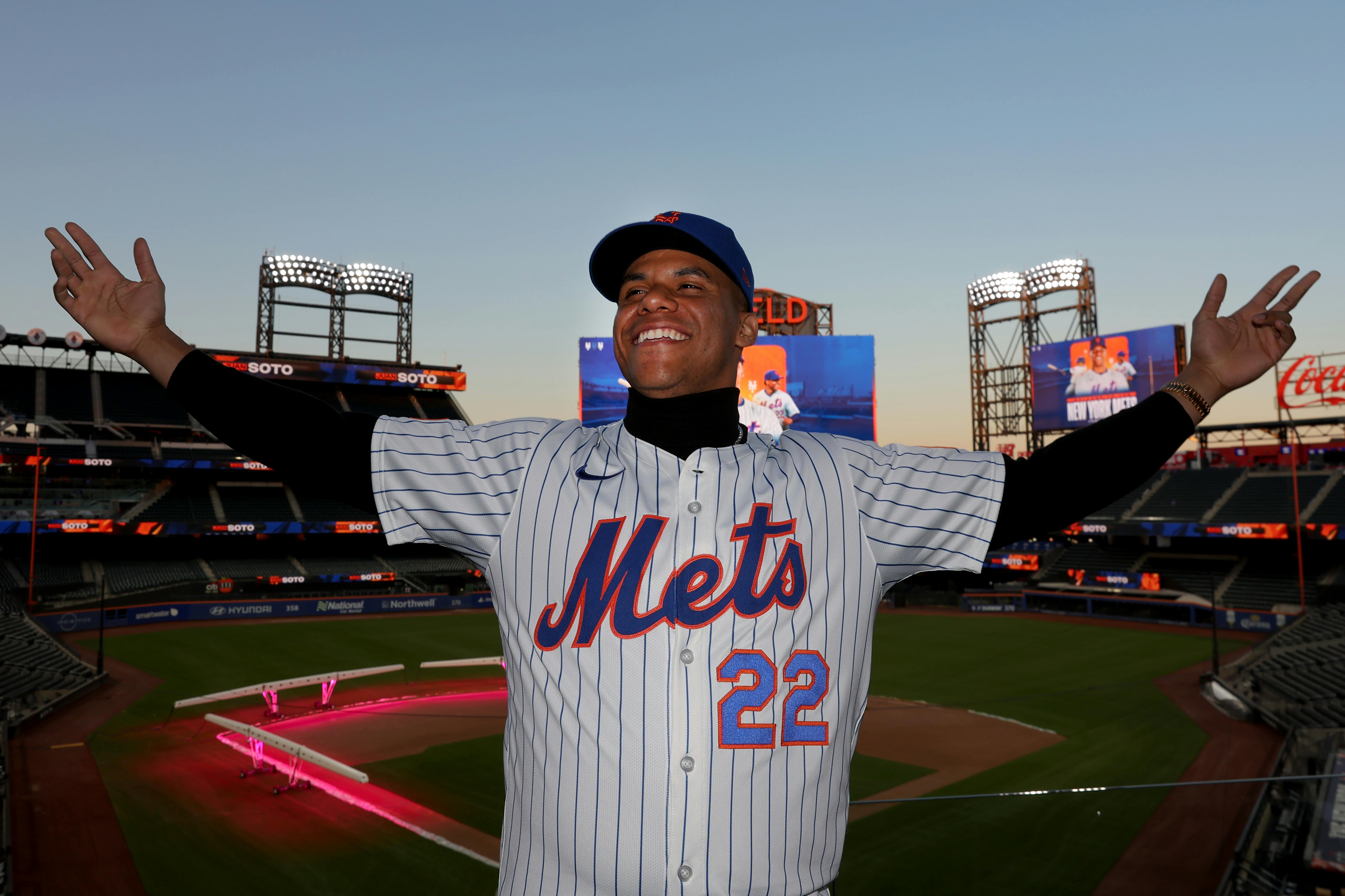 New York Mets right fielder Juan Soto poses for photos during his introductory press conference at Citi Field, and his addition has massively improved the Mets