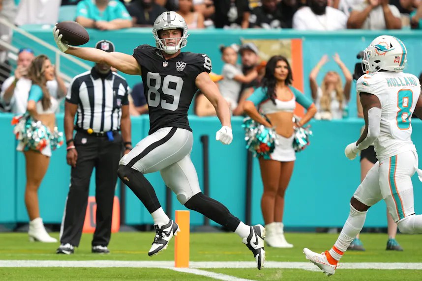 Las Vegas Raiders tight end Brock Bowers scores a touchdown past Miami Dolphins safety Jevon Holland. We're backing Bowers in our Raiders vs. Chiefs parlay.