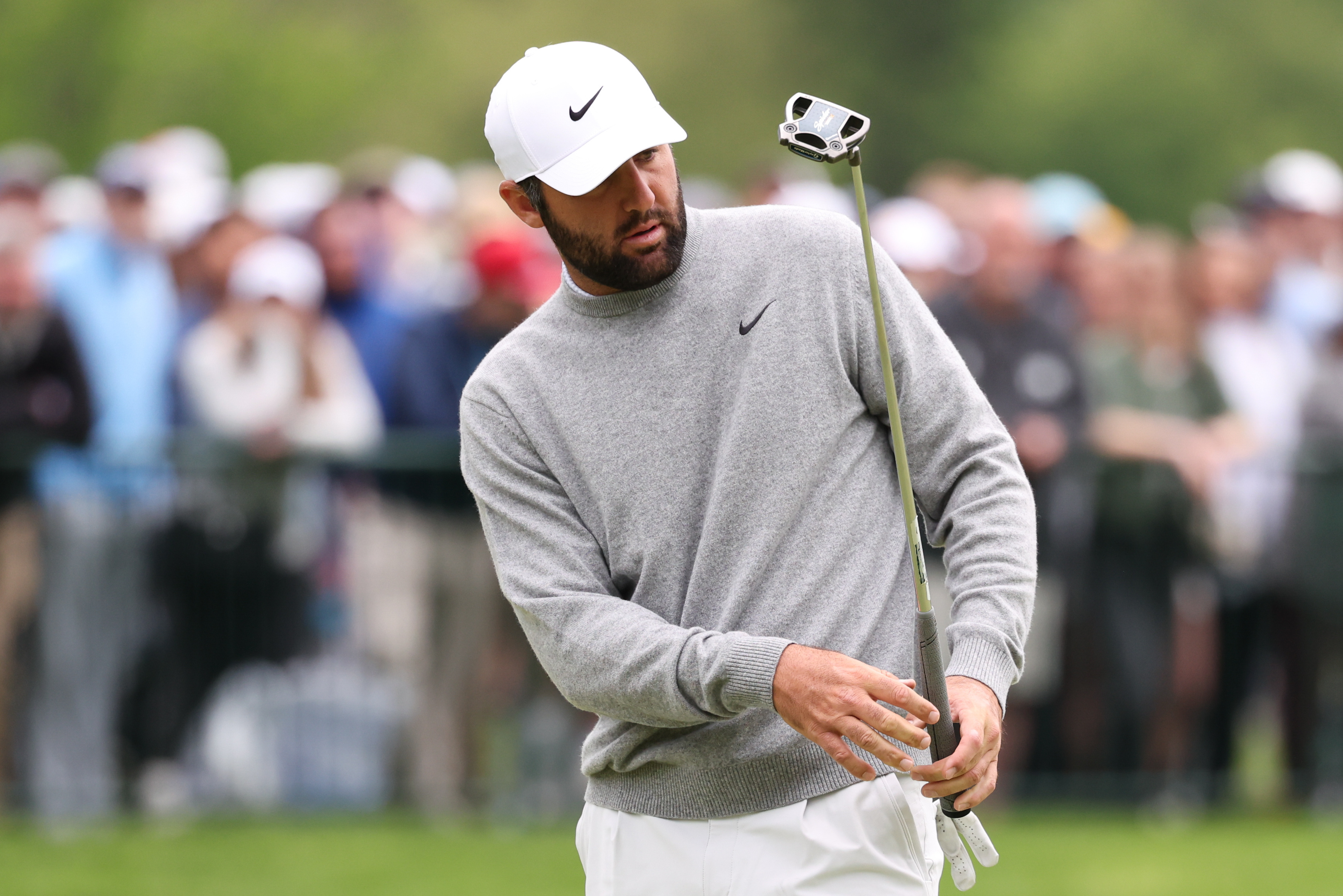 Scottie Scheffler - who's featued on the PGA Championship odds - putts on the eighteenth green during a practice round of the PGA Championship golf tournament at Aronimink Golf Club. 