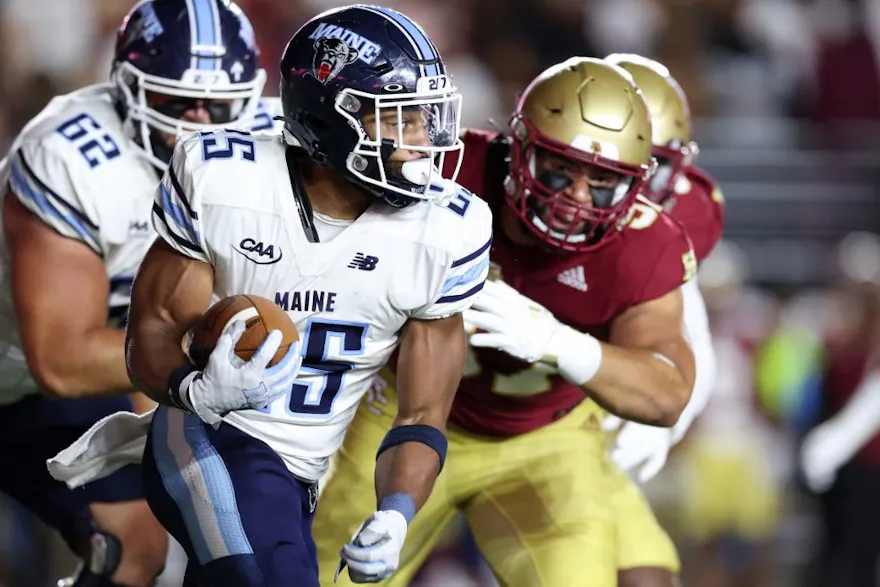 Tavion Banks #25 of the Maine Black Bears carries the ball as we look at the Maine sports betting revenue for November 2023.