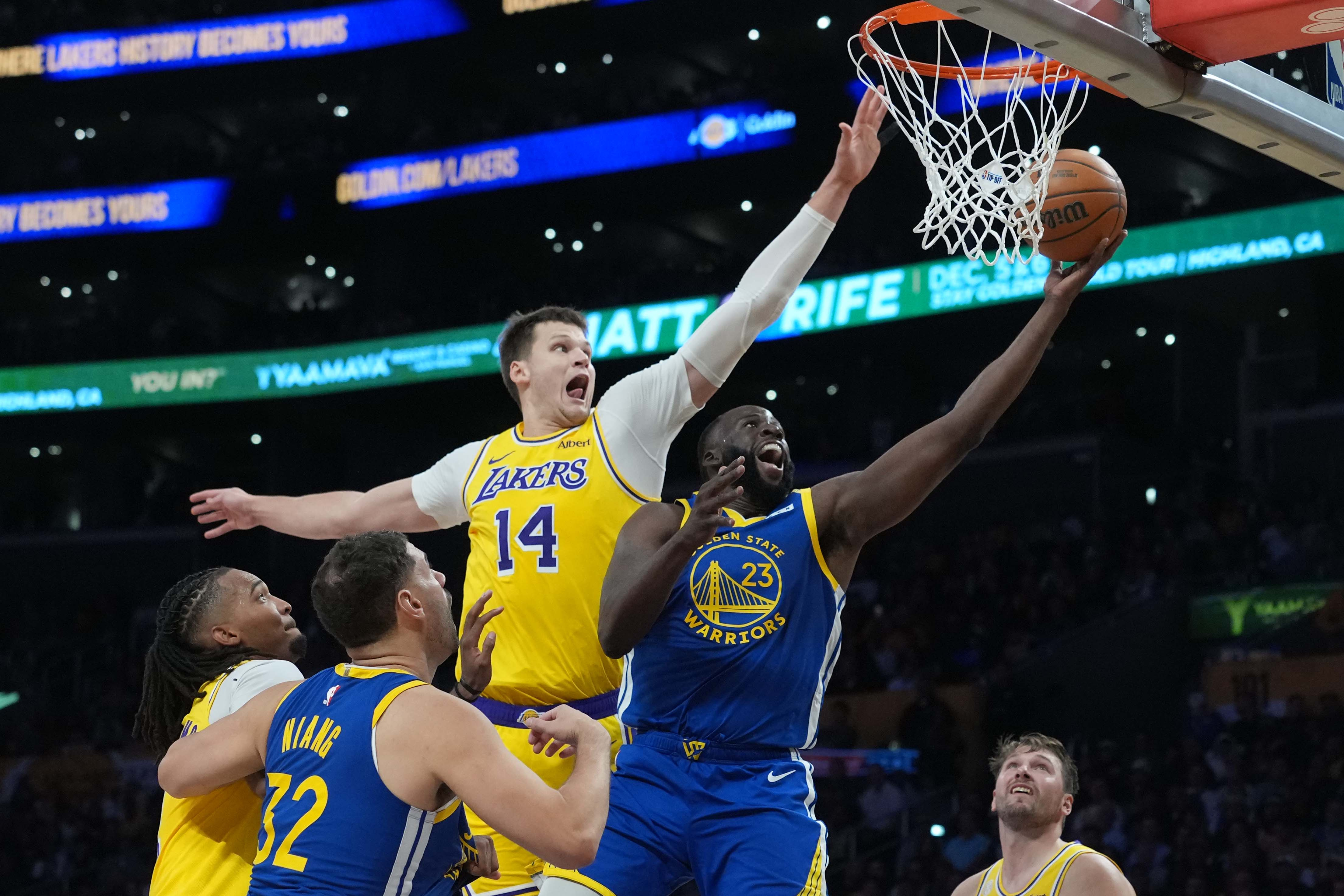Golden State Warriors forward Draymond Green (23) shoots the ball against Los Angeles Lakers center Walker Kessler (14), who is featured in our NBA best bets today.