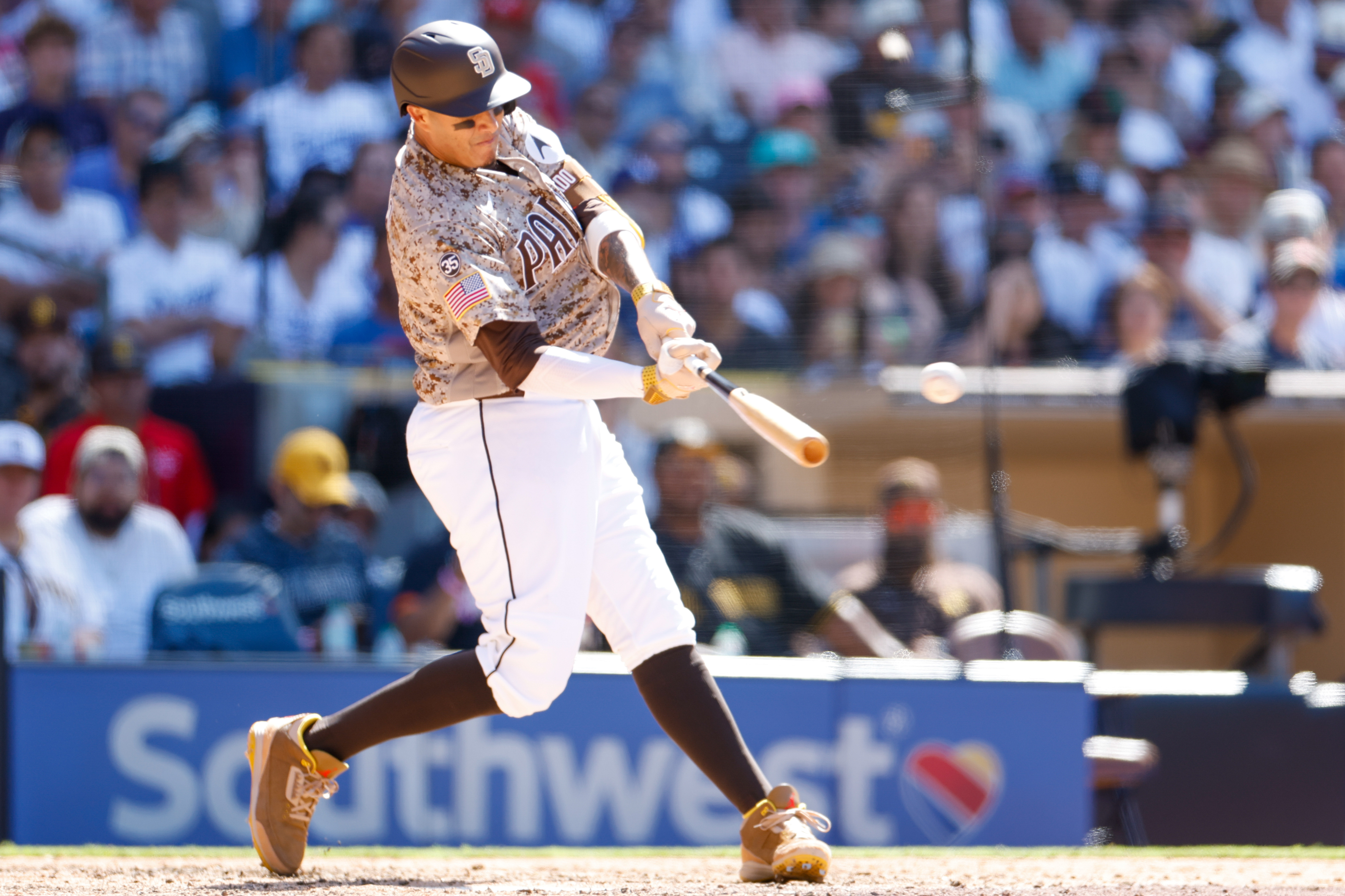 San Diego Padres third baseman Manny Machado (13) swings as we break down the Padres vs. Dodgers win probability.