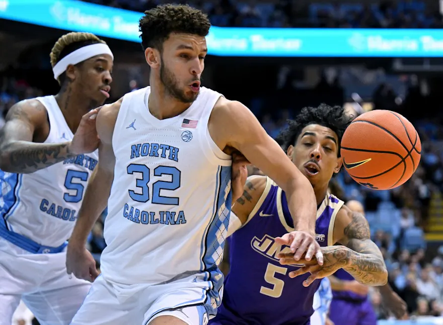 Pete Nance of the North Carolina Tar Heels and Terrence Edwards of the James Madison Dukes battle for a loose ball. We're expecting a big game from Edwards in ourJames Madison vs. Wisconsin player props and March Madness odds.