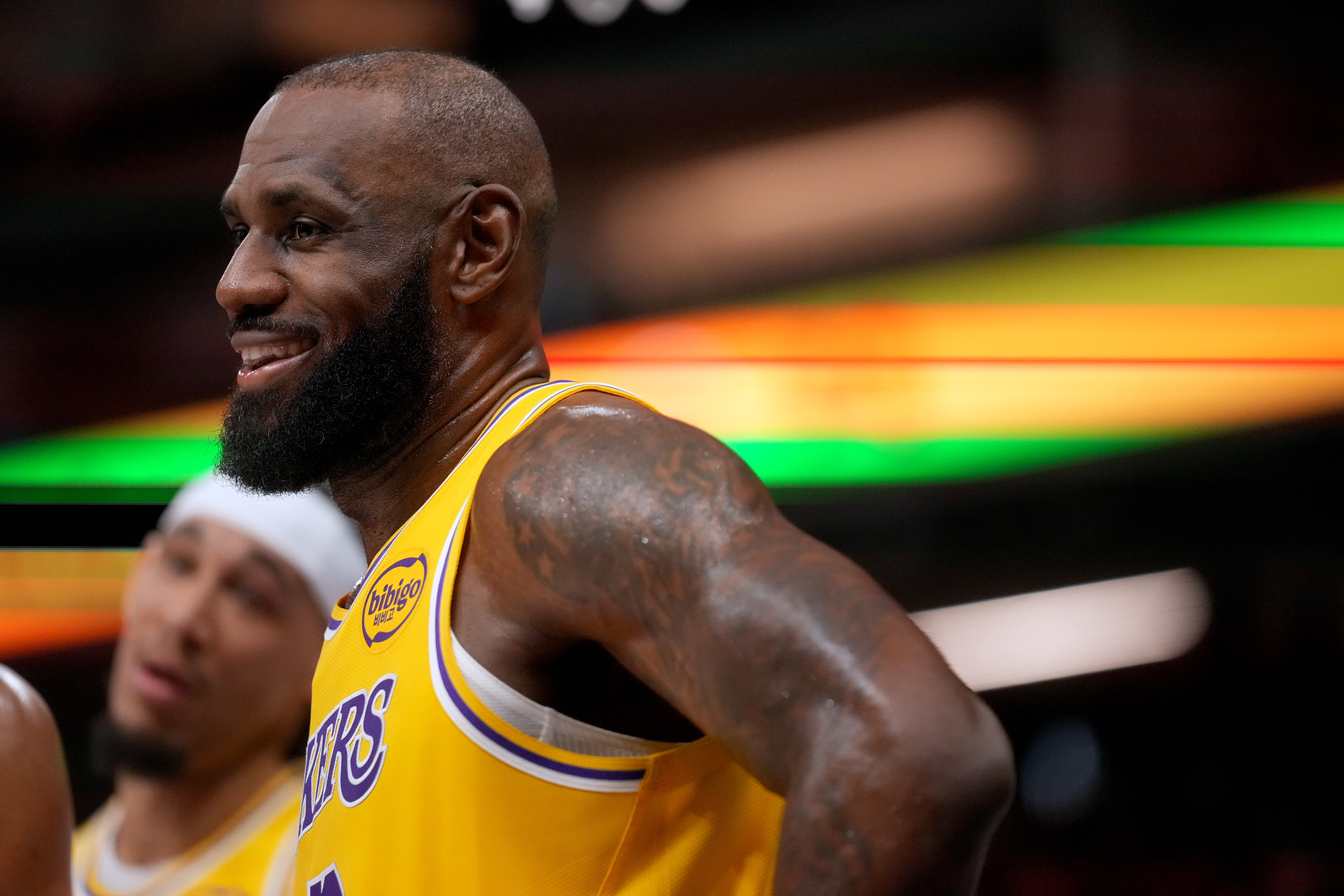 Los Angeles Lakers forward LeBron James (23), seen here smiling during a timeout, is featured in our NBA player props and best bets tonight.