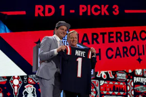 Drake Maye poses with NFL Commissioner Roger Goodell after being selected third overall by the New England Patriots during the first round of the 2024 NFL Draft. Maye is one of the many QBs we're breaking down the staring QB odds for.