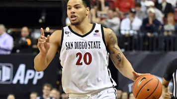 Matt Bradley of the San Diego State Aztecs brings the ball up court against the Utah State Aggies during the second half of the championship game in the Mountain West Conference basketball tournament.