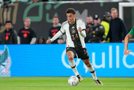 Germany midfielder Jamal Musiala dribbles the ball as we profile our Switzerland vs. Germany predictions for the final Group A game of Euro 2024. 