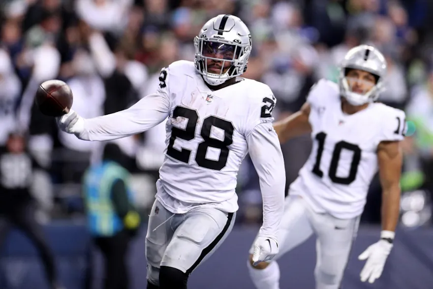 Josh Jacobs #28 of the Las Vegas Raiders carries the ball for a touchdown in overtime to beat the Seattle Seahawks 40-34 at Lumen Field on Nov. 27. 