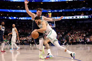 Jayson Tatum of the Boston Celtics goes to the basket against Luka Doncic of the Dallas Mavericks in the at American Airlines Center on January 22, 2024. We look at their matchup in our NBA Finals Odds & Betting Preview. 