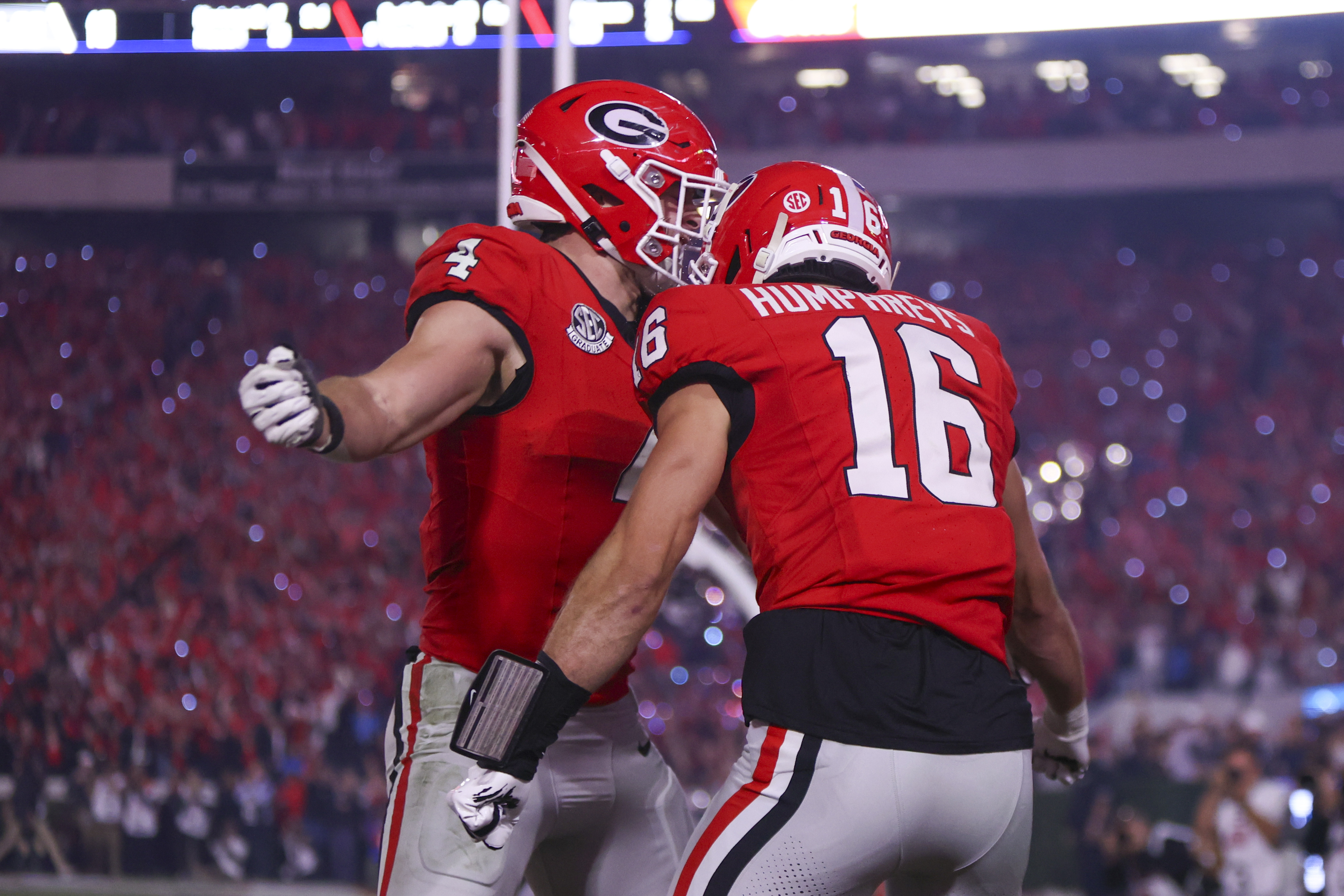 Georgia Bulldogs tight end Oscar Delp and wide receiver London Humphreys celebrate as we make our best Ole Miss vs. Georgia anytime touchdown scorer predictions