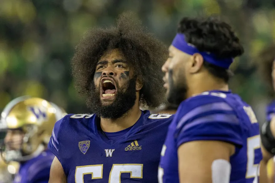 Offensive lineman Henry Bainivalu of the Washington Huskies cheers on the sidelines during the second half of the game against the Oregon Ducks.