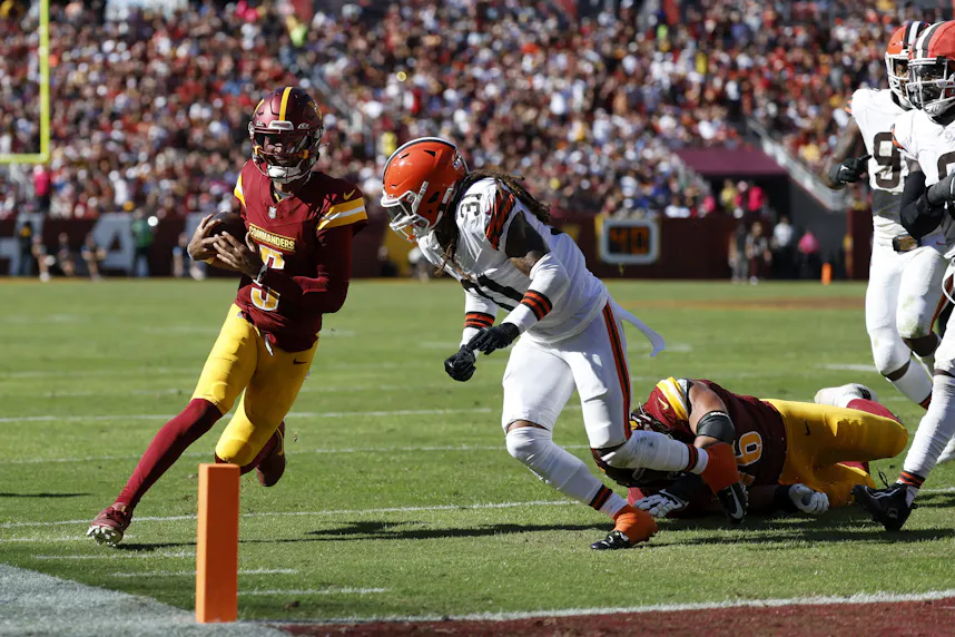 Washington Commanders quarterback Jayden Daniels runs with the ball as we offer our Commanders vs. Ravens player props.