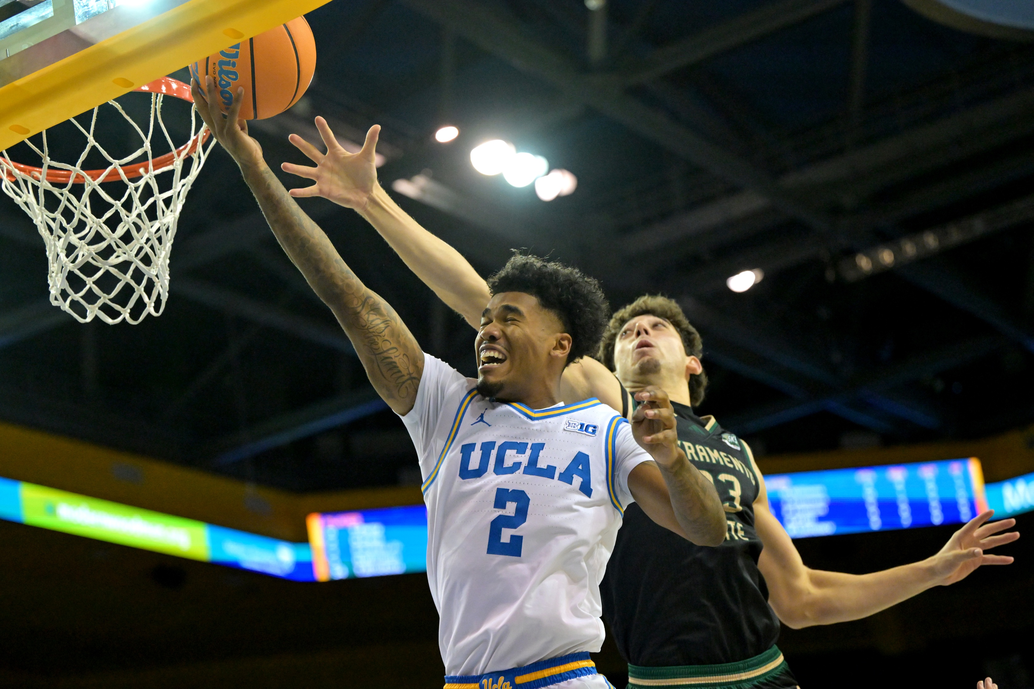UCLA Bruins guard Donovan Dent (2) scores as part of our UCLA vs. California prediction, betting odds & expert picks.