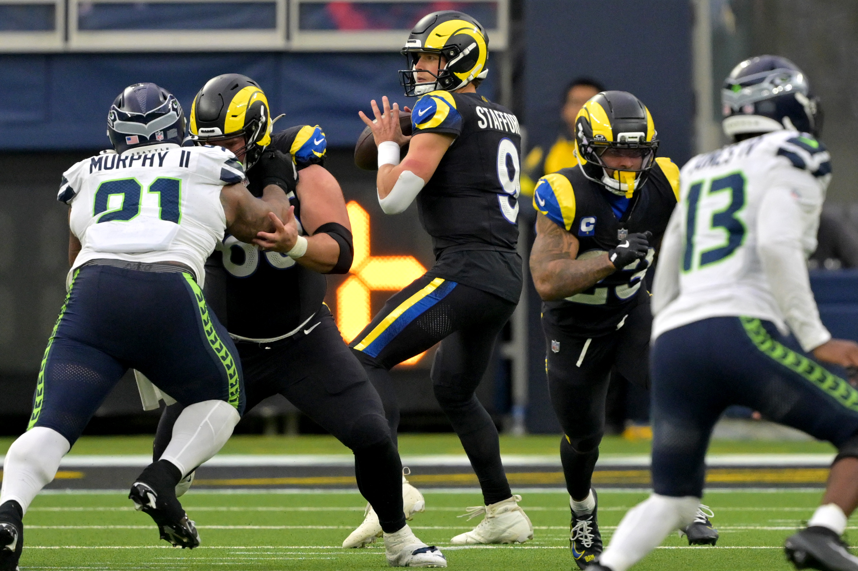 Matthew Stafford sets to pass against as we offer our Rams vs. Seahawks predictions and odds.
