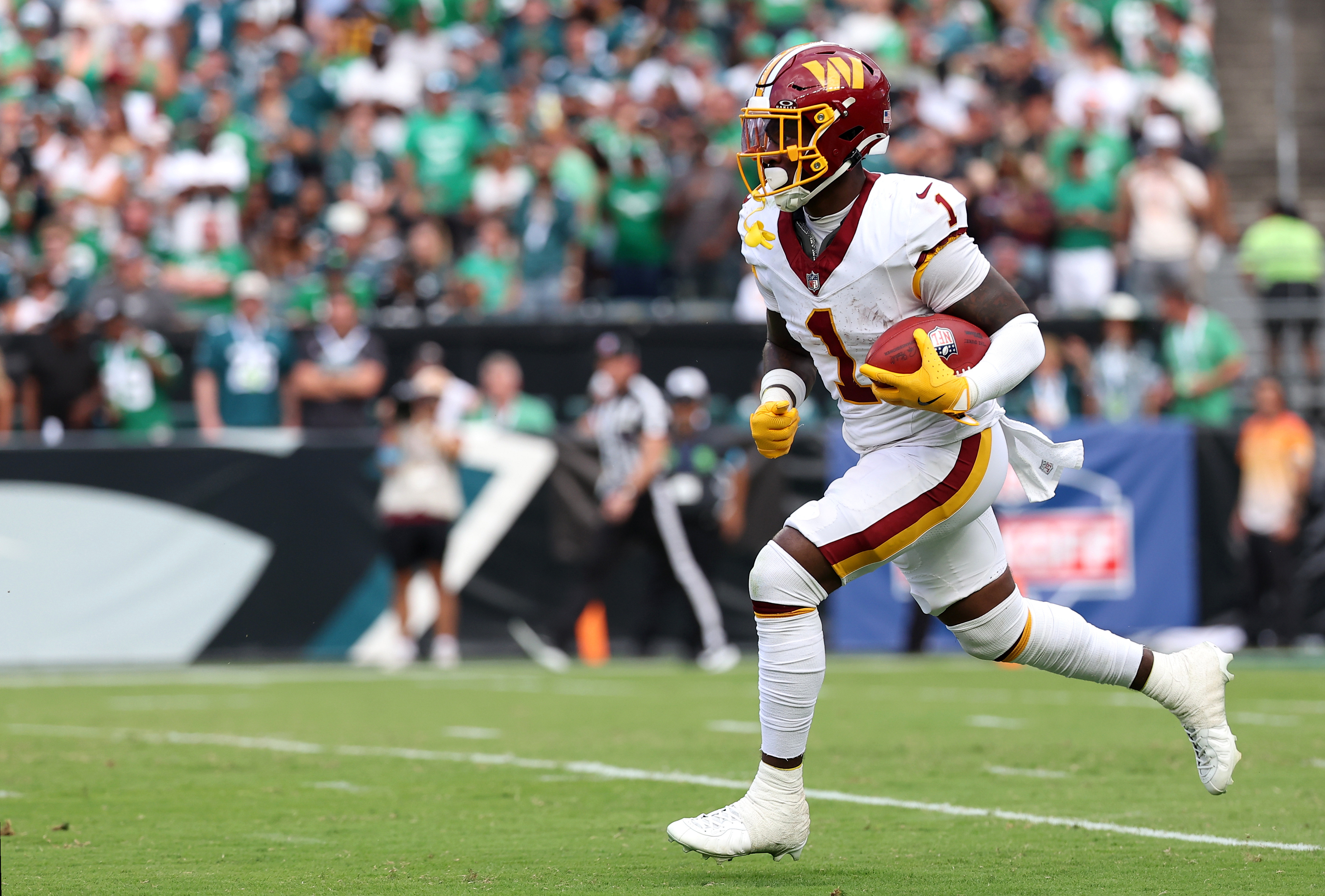 Washington Commanders running back Rachaad White (1) returns a kick as he is featured in our Commanders vs. 49ers touchdown scorer pick.